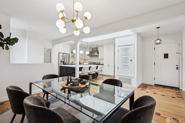 dining room featuring a chandelier and light wood-type flooring