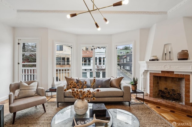 living room featuring a chandelier, a fireplace, and parquet floors