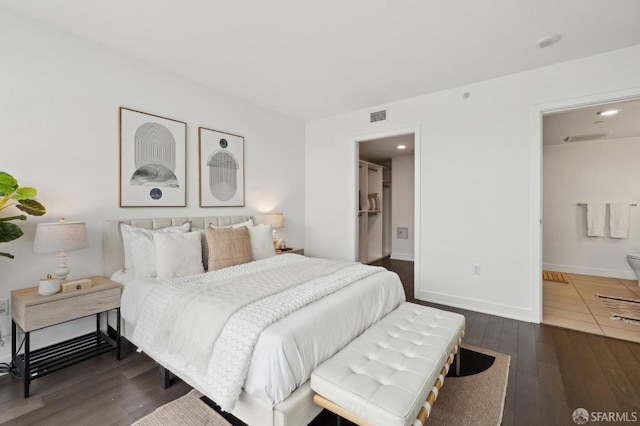 bedroom featuring dark hardwood / wood-style floors and ensuite bathroom