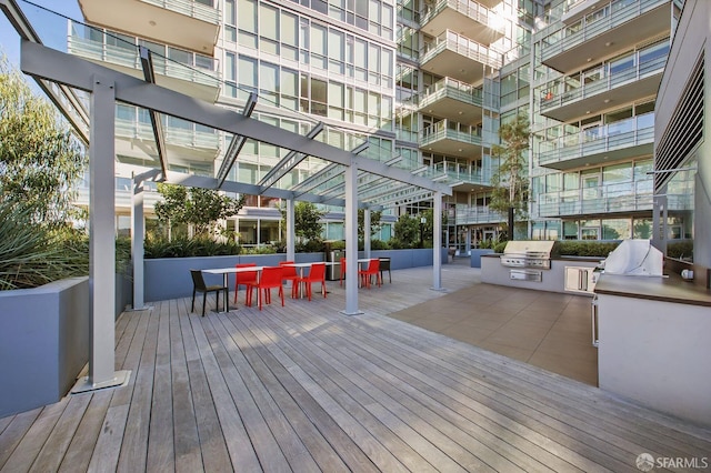 wooden terrace with grilling area and exterior kitchen