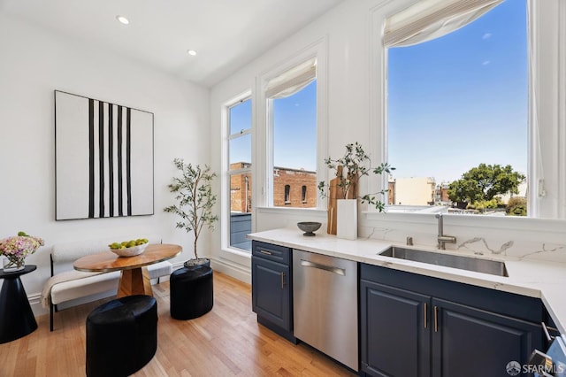 3470 20th St Unit 2, San Francisco, CA 94110 - kitchen featuring dishwasher, blue cabinets, light wood-type flooring, light stone counters, and recessed lighting