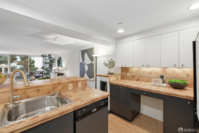 kitchen featuring sink, white cabinets, dishwasher, and tile counters