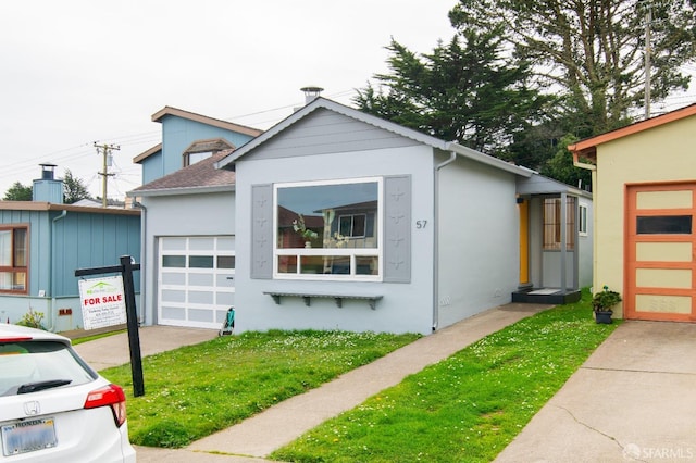 view of front of property with driveway, an attached garage, and stucco siding