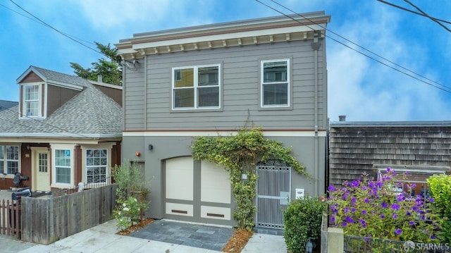 view of front of house featuring central air condition unit and a garage