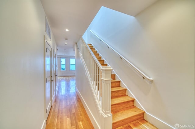 stairway featuring hardwood / wood-style floors