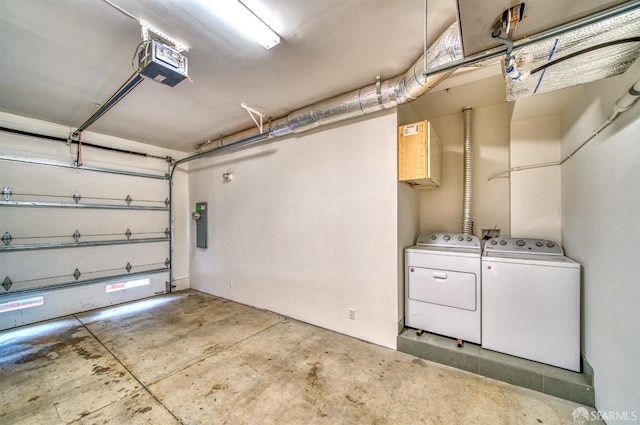 garage featuring a garage door opener, washing machine and dryer, and electric panel