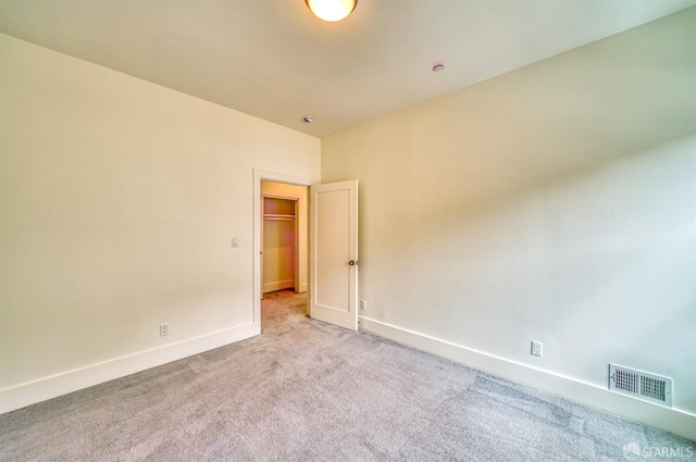 spare room featuring light colored carpet