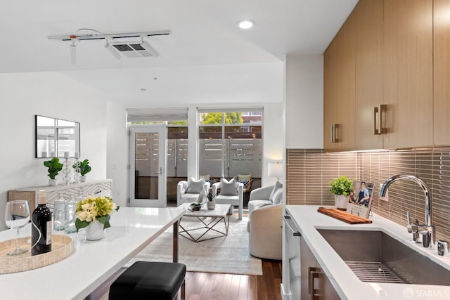 2655 Bush St Unit 119, San Francisco, CA 94115 - kitchen featuring modern cabinets, light countertops, backsplash, wood finished floors, and recessed lighting