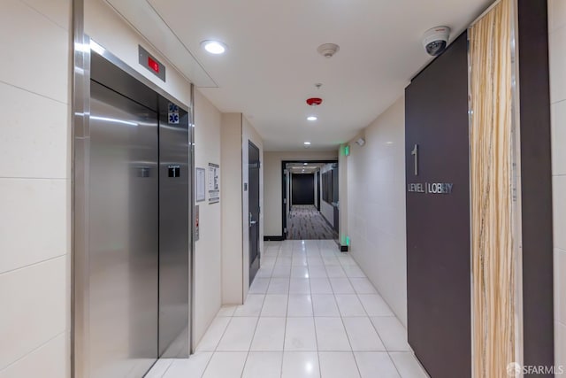 2655 Bush St Unit 119, San Francisco, CA 94115 - corridor with elevator, light tile patterned flooring, and recessed lighting