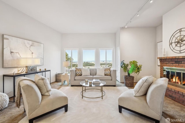 living room with track lighting and a fireplace