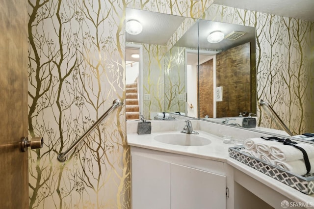 bathroom with vanity and a textured ceiling