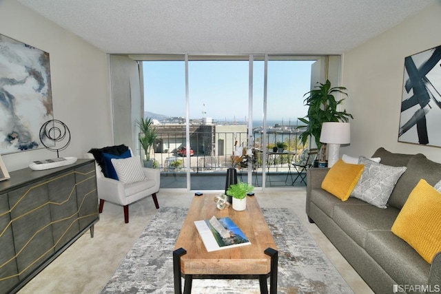 living room with carpet floors, expansive windows, and a textured ceiling