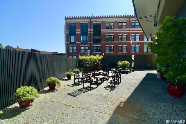 view of patio / terrace with a fire pit and fence