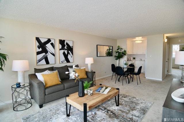 living room featuring a textured ceiling, baseboards, and light colored carpet