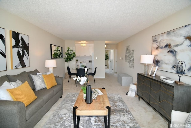 living area with a textured ceiling and light colored carpet