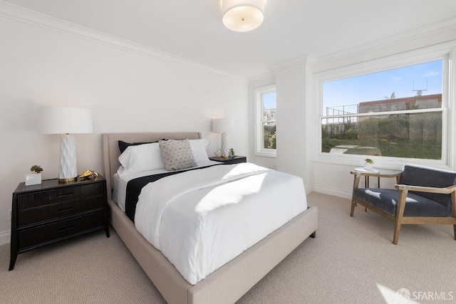 bedroom with ornamental molding, light carpet, and baseboards