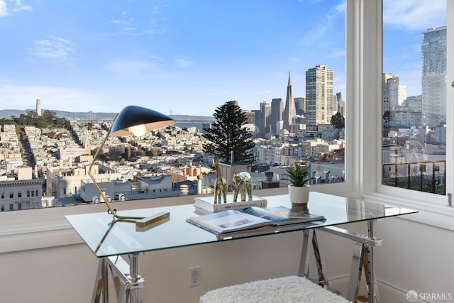 interior space with a balcony and a view of city