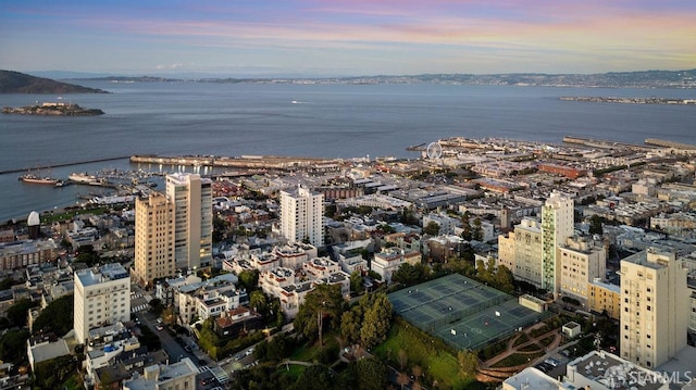 aerial view at dusk with a view of city and a water view