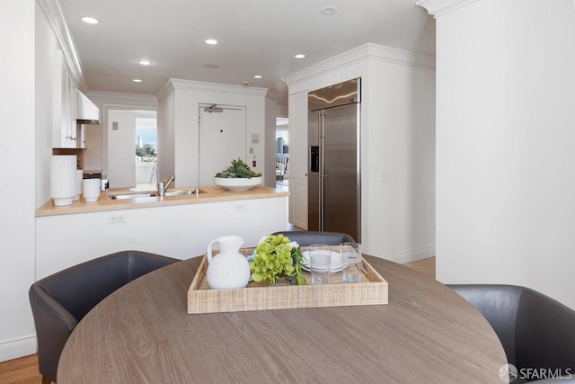 dining area featuring ornamental molding and recessed lighting