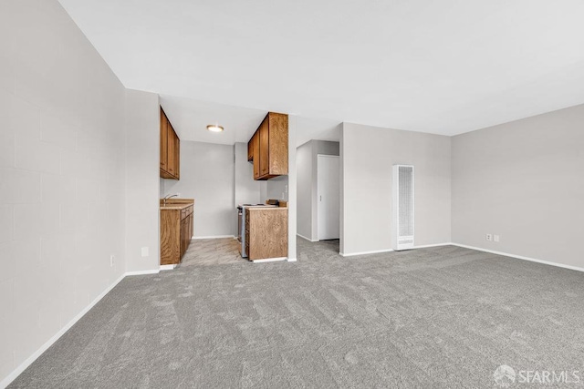 1315 Laguna St Unit 6, San Francisco, CA 94115 - unfurnished living room with light colored carpet, baseboards, a heating unit, and a sink