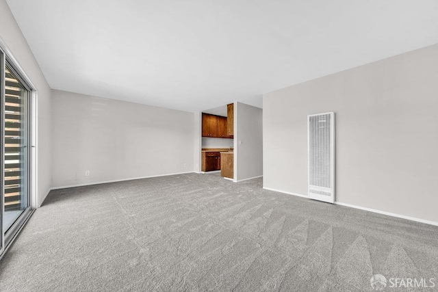 1315 Laguna St Unit 6, San Francisco, CA 94115 - unfurnished living room featuring a heating unit, carpet flooring, and baseboards