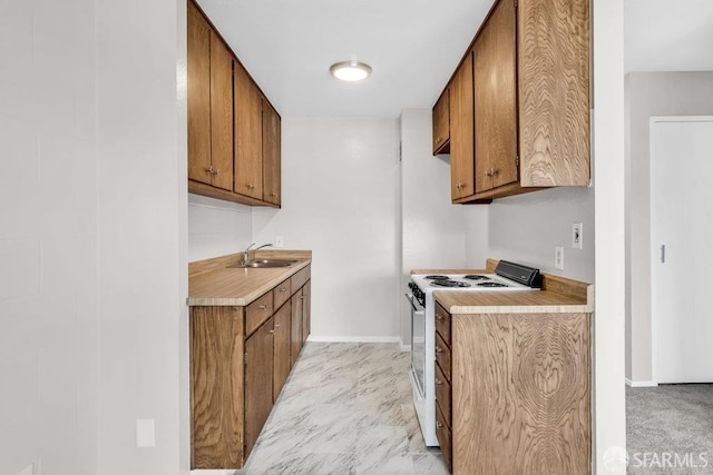 1315 Laguna St Unit 6, San Francisco, CA 94115 - kitchen featuring white range with electric cooktop, brown cabinets, light countertops, a sink, and baseboards