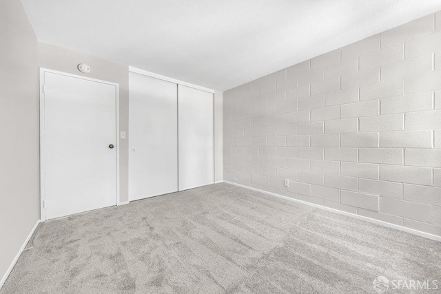 1315 Laguna St Unit 6, San Francisco, CA 94115 - unfurnished bedroom with carpet flooring, concrete block wall, and a closet