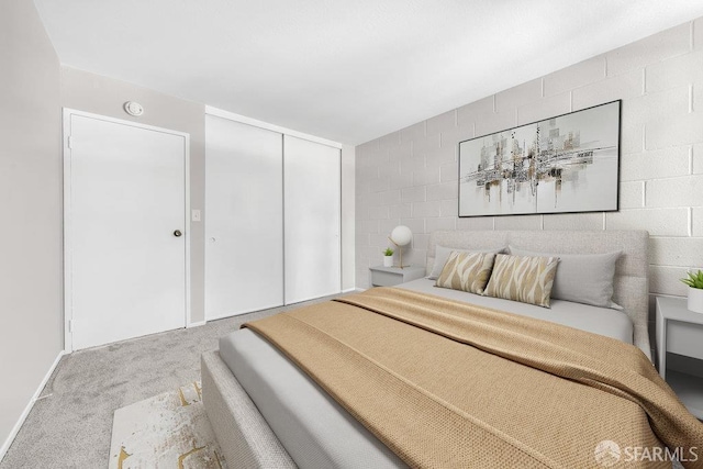 1315 Laguna St Unit 6, San Francisco, CA 94115 - bedroom with carpet floors, concrete block wall, and a closet