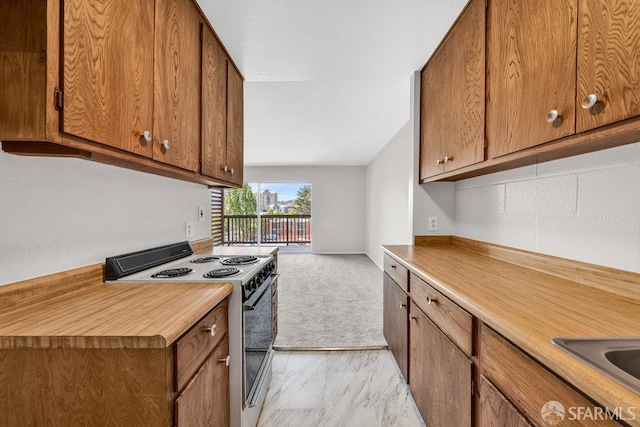 1315 Laguna St Unit 6, San Francisco, CA 94115 - kitchen with range with electric stovetop, brown cabinets, and light countertops