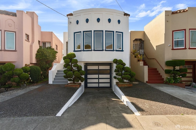 149 Capistrano Ave, San Francisco, CA 94112 - view of front of property featuring stucco siding, stairway, concrete driveway, and a garage