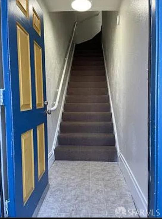 stairs featuring a textured wall