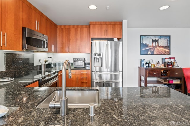 38 N Almaden Blvd Unit 1419, San Jose, CA 95110 - kitchen with appliances with stainless steel finishes, brown cabinets, dark stone countertops, recessed lighting, and a sink