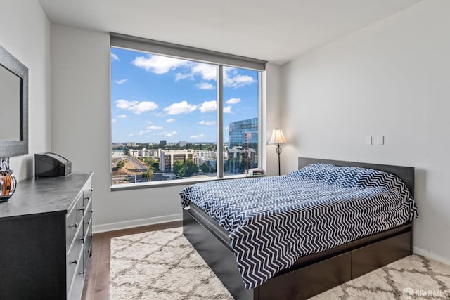 38 N Almaden Blvd Unit 1419, San Jose, CA 95110 - bedroom with wood finished floors, baseboards, and a city view