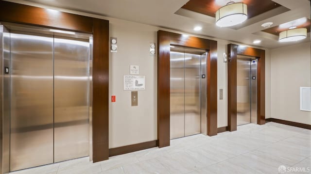 38 N Almaden Blvd Unit 1419, San Jose, CA 95110 - corridor with elevator, baseboards, a tray ceiling, and recessed lighting