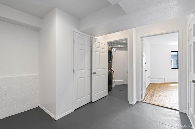 11 Sparta St, San Francisco, CA 94134 - unfurnished bedroom with stacked washer and clothes dryer, concrete floors, and baseboards