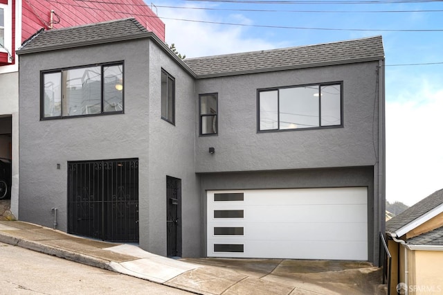 11 Sparta St, San Francisco, CA 94134 - view of front facade with a garage, stucco siding, and a shingled roof