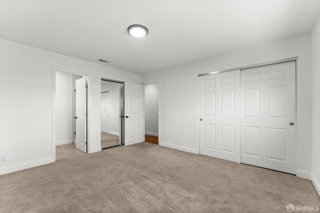 unfurnished bedroom featuring light carpet