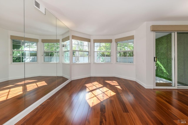 unfurnished sunroom with visible vents