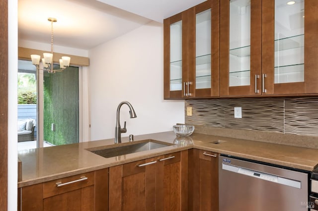 kitchen featuring hanging light fixtures, glass insert cabinets, brown cabinetry, a sink, and dishwasher