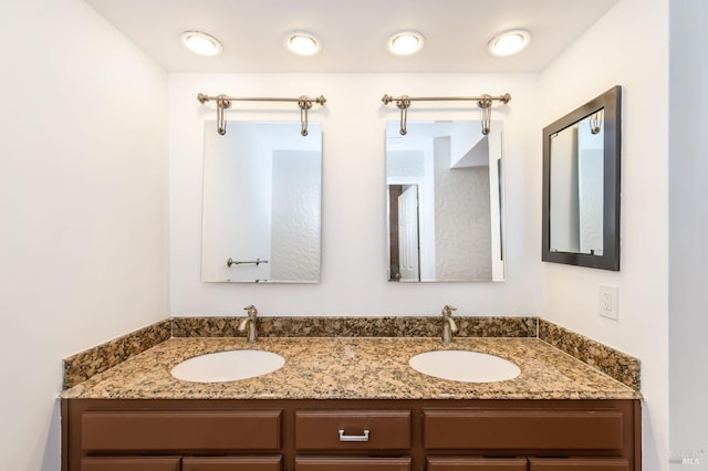 full bath with a sink and double vanity