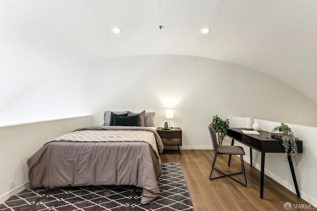 bedroom with baseboards, recessed lighting, wood finished floors, and vaulted ceiling