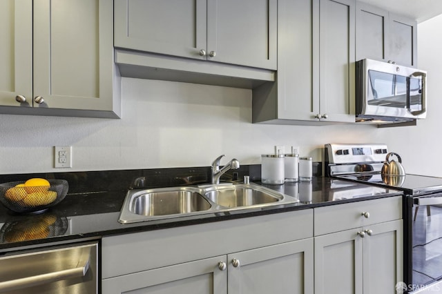 kitchen featuring a sink, gray cabinetry, and stainless steel appliances