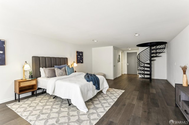 bedroom with recessed lighting and wood finished floors