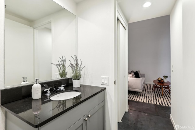 bathroom featuring recessed lighting, baseboards, and vanity