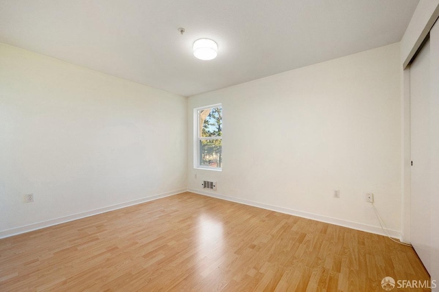 spare room featuring light hardwood / wood-style flooring