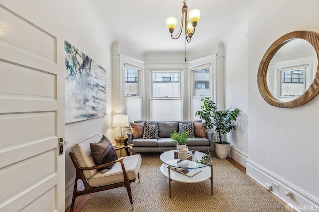 living area featuring a notable chandelier and hardwood / wood-style floors