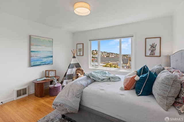 bedroom with wood finished floors and baseboards