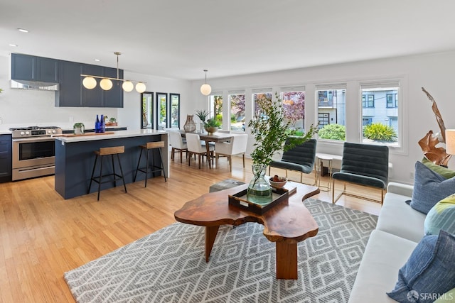 living area featuring light wood-type flooring and recessed lighting