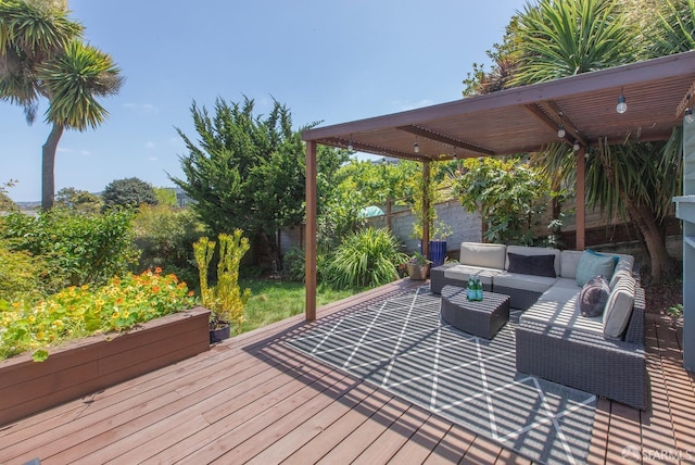 wooden terrace featuring an outdoor living space and a fenced backyard