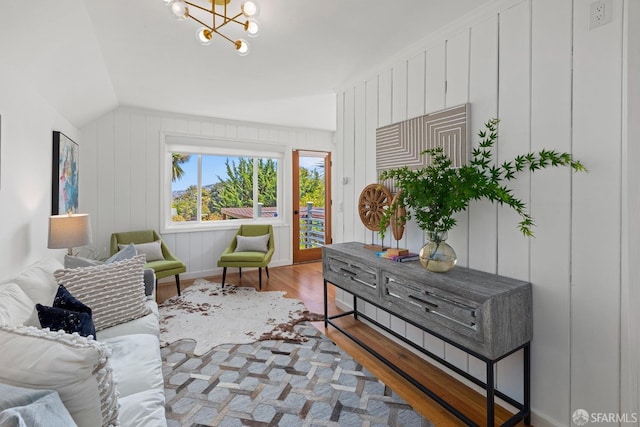 sitting room featuring wood finished floors, lofted ceiling, and a chandelier